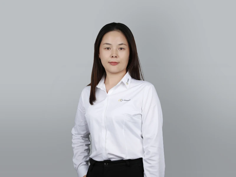 Jenny in a white outfit with one hand in her pocket