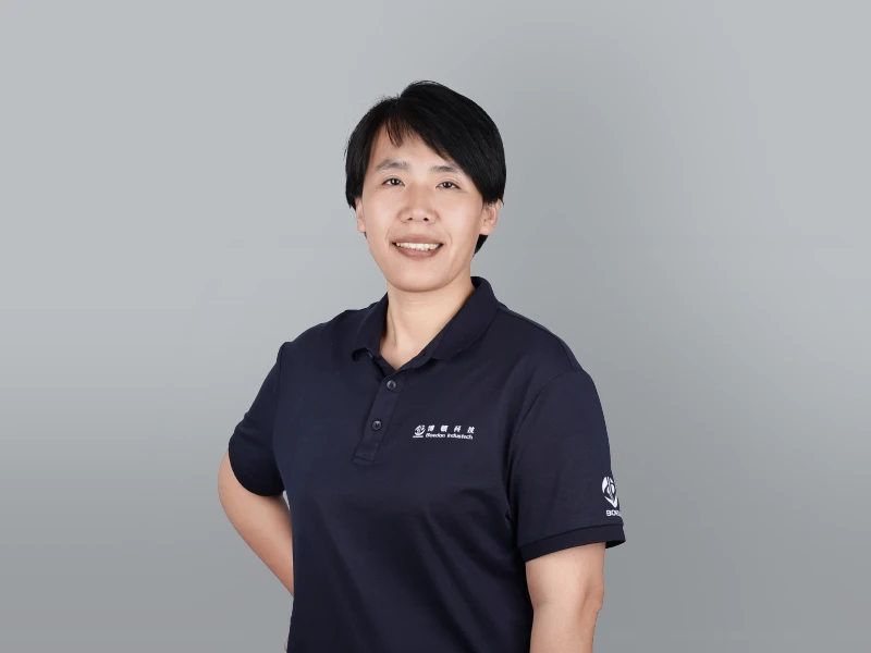 Nancy in a black outfit with one hand behind her back