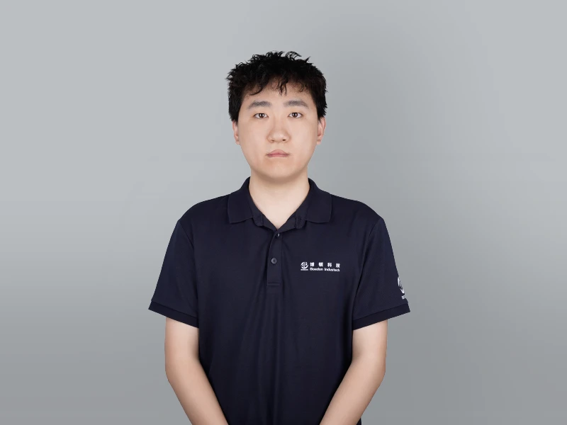 Niko, dressed in black, looks straight ahead