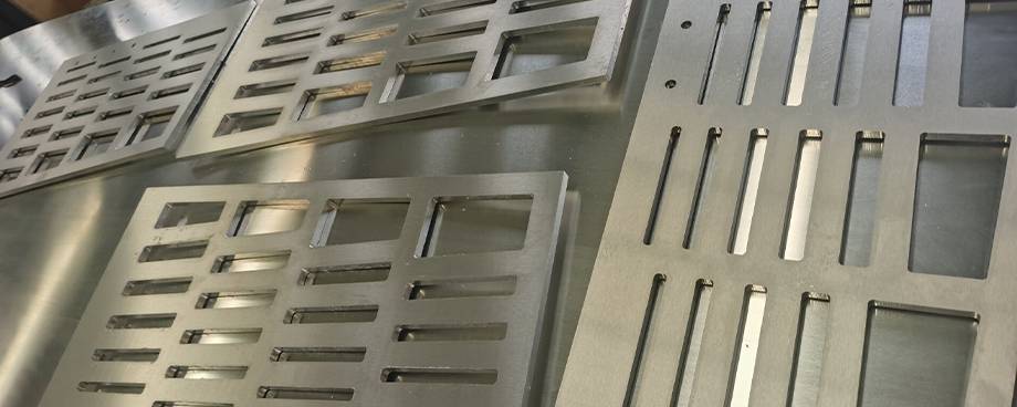 4 uncolored CNC perforated metal plates are displayed.