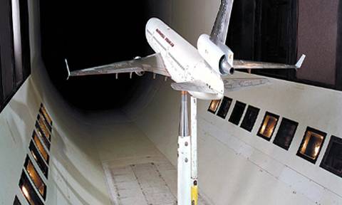An airplane model undergoes a wind tunnel test.